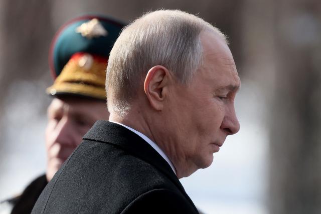 Russia's President Vladimir Putin leaves after a wreath-laying ceremony at the Tomb of the Unknown Soldier by the Kremlin Wall to mark Defender of the Fatherland Day in Moscow on February 23, 2026. (Photo by Maxim SHIPENKOV / POOL / AFP)