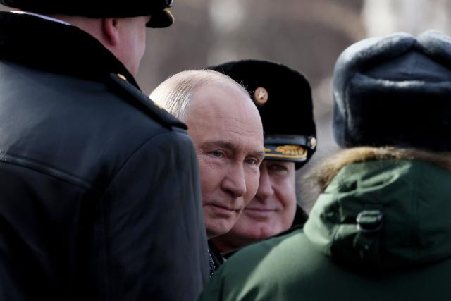 Russia's President Vladimir Putin leaves after a wreath-laying ceremony at the Tomb of the Unknown Soldier by the Kremlin Wall to mark Defender of the Fatherland Day in Moscow on February 23, 2026. (Photo by Maxim SHIPENKOV / POOL / AFP)