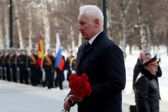 Russia's Defence Minister Andrei Belousov takes part in a wreath-laying ceremony at the Tomb of the Unknown Soldier by the Kremlin Wall to mark Defender of the Fatherland Day in Moscow on February 23, 2026. (Photo by Maxim SHIPENKOV / POOL / AFP)
