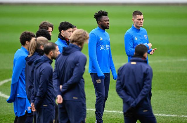 Bayer Leverkusen's Czech forward #14 Patrik Schick (R), Bayer Leverkusen's Burkinabe defender #12 Edmond Tapsoba (2nd R), Bayer Leverkusen's Algerian midfielder #30 Ibrahim Maza (3rd R) and team players attend a training session on February 23, 2026 in Leverkusen, western Germany, on the eve of the UEFA Champions League - Knockout round play-off - Second Leg football match of Bayer Leverkusen (GER) v Olympiakos (GRE). (From L) Guest, Guest, Guest, Algeria's midfielder #22 Ibrahim Maza, Burkina Faso's defender #12 Edmond Tapsoba and Czech Republic's forward Patrik Schick (Photo by INA FASSBENDER / AFP)