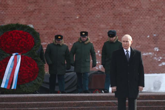 In this pool photograph distributed by the Russian state agency Sputnik, Russia's President Vladimir Putin attends a wreath-laying ceremony at the Tomb of the Unknown Soldier by the Kremlin Wall to mark Defender of the Fatherland Day in Moscow on February 23, 2026. (Photo by Sergey FADEICHEV / POOL / AFP)