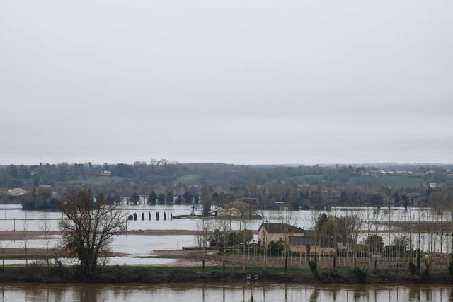 This photograph shows houses encircled by the floodwaters of the River Garonne in La Reole, southwestern France, on February 23, 2026. (Photo by ROMAIN PERROCHEAU / AFP)