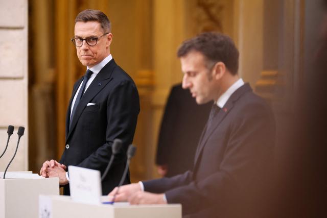France's President Emmanuel Macron and Finland's President Alexander Stubb (L) hold a joint statement at The Elysee Presidential Palace in Paris on February 23, 2026. (Photo by Thomas Padilla / POOL / AFP)