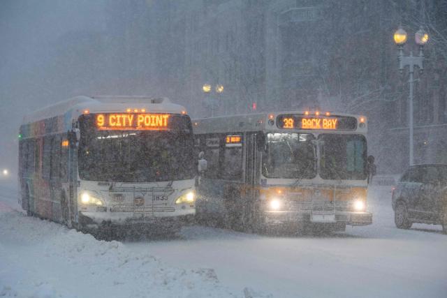 Busses come to a stop during blizzard conditions in Boston, Massachusetts on February 23, 2026. Tens of millions of Americans from the US capital Washington to the northern state of Maine prepared for up to two feet (60 centimeters) of snow forecast in some areas. The National Weather Service (NWS) said blizzard conditions would "quickly materialize" from Maryland up to southeastern New England, making travel "extremely treacherous." (Photo by Joseph Prezioso / AFP)