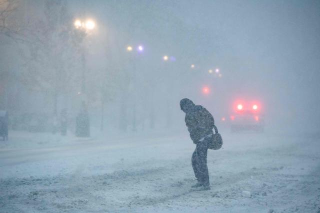 A person walks through Copley Square during blizzard conditions in Boston, Massachusetts on February 23, 2026. Tens of millions of Americans from the US capital Washington to the northern state of Maine prepared for up to two feet (60 centimeters) of snow forecast in some areas. The National Weather Service (NWS) said blizzard conditions would "quickly materialize" from Maryland up to southeastern New England, making travel "extremely treacherous." (Photo by Joseph Prezioso / AFP)