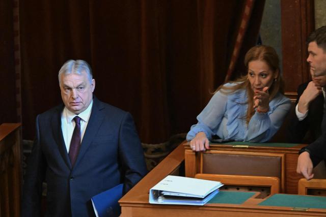 Hungarian Prime Minister Viktor Orban (L) arrives to the hall prior to the spring session of the Hungarian Parliament in Budapest, Hungary, on February 23, 2026. The nationalist leader is facing the toughest challenge since returning to power in 2010, with his Fidesz party trailing the opposition TISZA party in opinion polls ahead of parliamentary elections on April 12, 2026. (Photo by Attila KISBENEDEK / AFP)