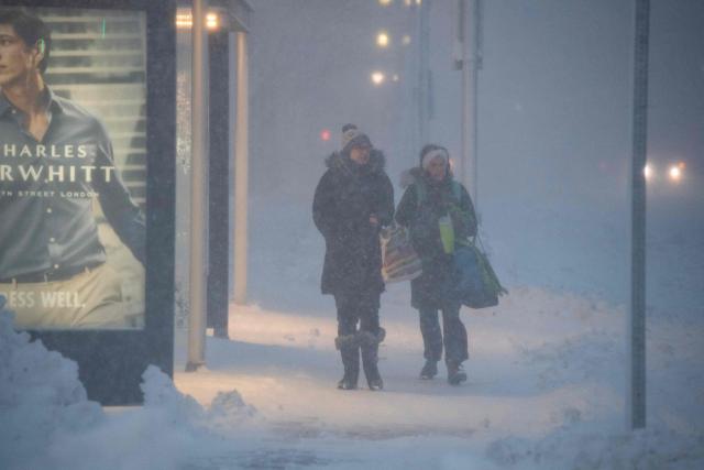 People walk through Copley Square during blizzard conditions in Boston, Massachusetts on February 23, 2026. Tens of millions of Americans from the US capital Washington to the northern state of Maine prepared for up to two feet (60 centimeters) of snow forecast in some areas. The National Weather Service (NWS) said blizzard conditions would "quickly materialize" from Maryland up to southeastern New England, making travel "extremely treacherous." (Photo by Joseph Prezioso / AFP)