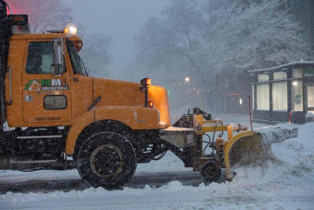 A plow clears the streets of snow during blizzard conditions in Boston, Massachusetts on February 23, 2026. Tens of millions of Americans from the US capital Washington to the northern state of Maine prepared for up to two feet (60 centimeters) of snow forecast in some areas. The National Weather Service (NWS) said blizzard conditions would "quickly materialize" from Maryland up to southeastern New England, making travel "extremely treacherous." (Photo by Joseph Prezioso / AFP)
