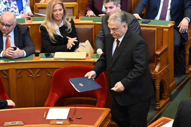 Hungarian Prime Minister Viktor Orban (R) arrives to a seat prior to the spring session of the Hungarian Parliament in Budapest, Hungary, on February 23, 2026. The nationalist leader is facing the toughest challenge since returning to power in 2010, with his Fidesz party trailing the opposition TISZA party in opinion polls ahead of parliamentary elections on April 12, 2026. (Photo by Attila KISBENEDEK / AFP)