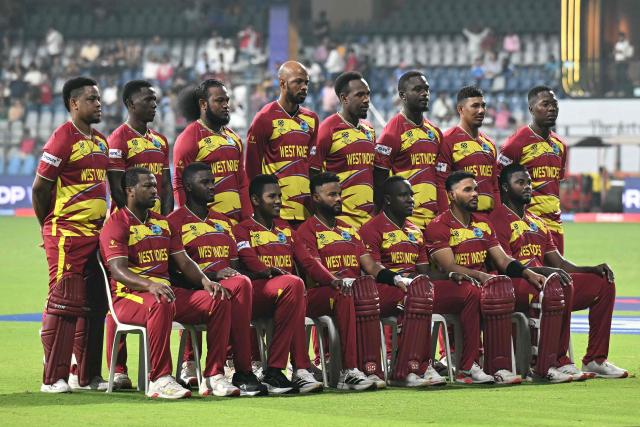 West Indies team players pose for a group photograph before the start of the 2026 ICC Men's T20 Cricket World Cup Super Eights match between West Indies and Zimbabwe at the Wankhede Stadium in Mumbai on February 23, 2026. (Photo by Punit PARANJPE / AFP)
