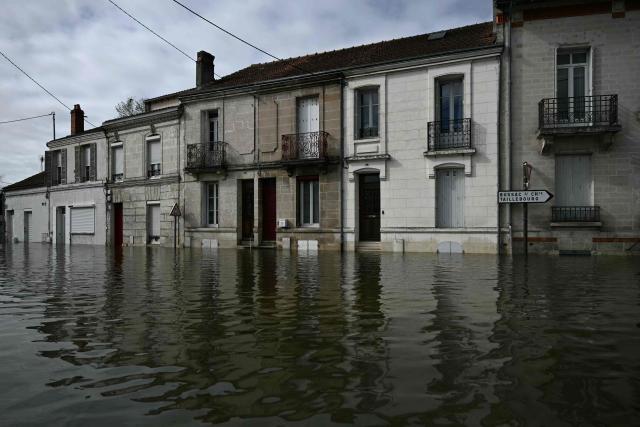 This photograph shows a flooded street following severe flooding from storm Nils in Saintes, north of Bordeaux, on February 23, 2026. (Photo by Philippe LOPEZ / AFP)