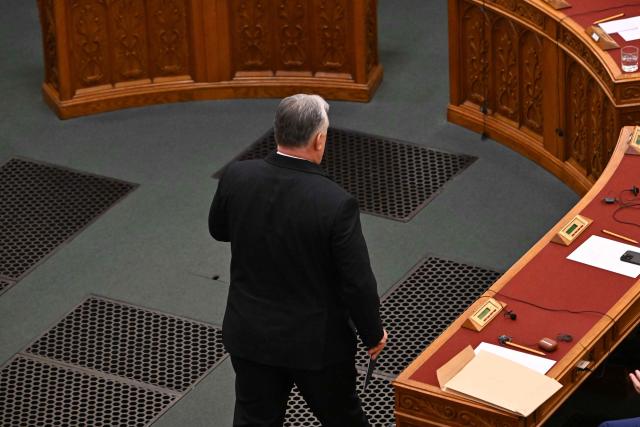 Hungarian Prime Minister Viktor Orban walks back to his place after addressing a speech before the agenda in the main hall of the parliament building during the spring session of the Hungarian Parliament in Budapest, Hungary, on February 23, 2026. The nationalist leader is facing the toughest challenge since returning to power in 2010, with his Fidesz party trailing the opposition TISZA party in opinion polls ahead of parliamentary elections on April 12, 2026. (Photo by Attila KISBENEDEK / AFP)