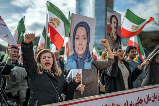 Protesters hold up portraits of Iranian dissident politician Maryam Rajavi and Massoud Rajavi (R) during a demonstration in front of the United Nations Offices on the sideline of the 61st session of the UN Human Rights Council in Geneva on February 23, 2026. (Photo by Fabrice COFFRINI / AFP)