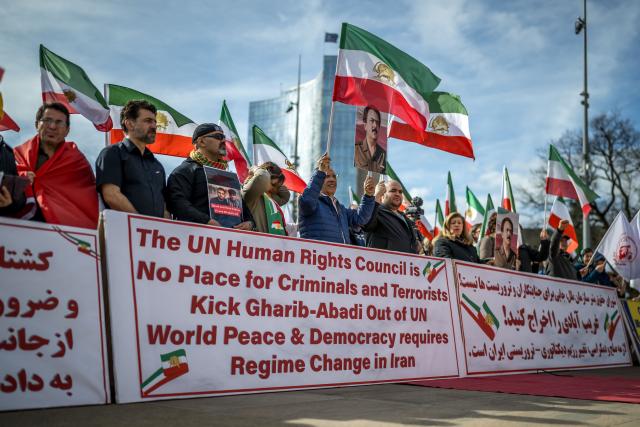 Protesters hold up portraits of Iranian dissident politician Massoud Rajavi during a demonstration in front of the United Nations Offices on the sideline of the 61st session of the UN Human Rights Council in Geneva on February 23, 2026. (Photo by Fabrice COFFRINI / AFP)