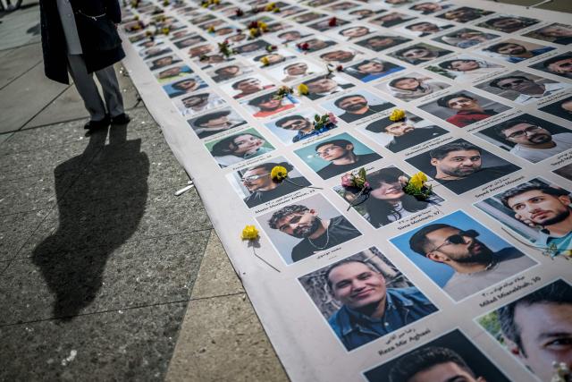 Portraits of killed Iranian protesters are displayed during a demonstration against the Iranian regime on the sideline of the 61st session of the UN Human Rights Council in Geneva on February 23, 2026. (Photo by Fabrice COFFRINI / AFP)