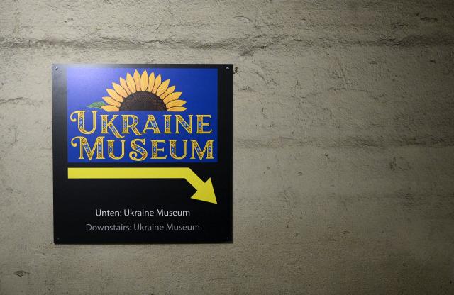 The entrance to the Berlin Story Bunker with a sign reading 'Ukraine Museum' is pictured during a press presentation of the "Ukraine Museum" in the "Berlin Story Bunker" on February 23, 2026 in Berlin, one day before the exhibition's opening to the public and the fourth anniversary of Russia's invasion in Ukraine. Covering 300 square meters, the former World War II bunker in Berlin's Story Bunker will display various Russian combat drones and a destroyed Ukrainian evacuation vehicle. (Photo by RALF HIRSCHBERGER / AFP)