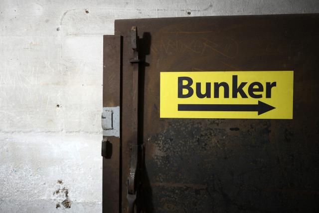 The entrance to the Berlin Story Bunker with a sign reading 'Bunker' is pictured during a press presentation of the "Ukraine Museum" in the "Berlin Story Bunker" on February 23, 2026 in Berlin, one day before the exhibition's opening to the public and the fourth anniversary of Russia's invasion in Ukraine. Covering 300 square meters, the former World War II bunker in Berlin's Story Bunker will display various Russian combat drones and a destroyed Ukrainian evacuation vehicle. (Photo by RALF HIRSCHBERGER / AFP)