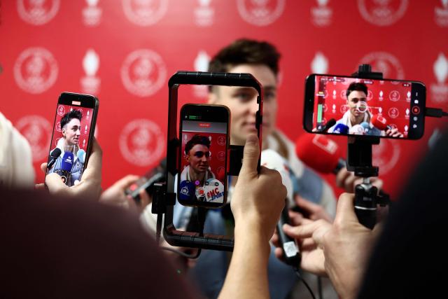 France's biathlete Eric Perrot talks to the press before the official celebration of the return of the athletes of the French delegation from the Milano Cortina 2026 Winter Olympic Games in Albertville, south-eastern France on February 23, 2026, as the Olympic flag arrives in the French Alps for the 2030 Olympic Games. (Photo by Alex MARTIN / AFP)