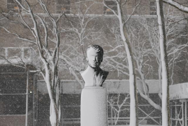 Snow rests upon a statue during a winter storm in the Brooklyn borough of New York City on February 23, 2026. New York ordered drivers off the road and shut down schools on Monday, while residents hunkered down for a massive snowstorm hitting the United States northeast. The National Weather Service (NWS) said in a post on X that "heavy snow is still falling" at 5:28 am local time (1028 GMT) on Monday adding that a the total snowfall stands at 14.9 inches. (Photo by ANGELA WEISS / AFP)
