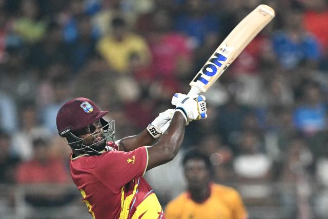 West Indies' Romario Shepherd plays a shot during the 2026 ICC Men's T20 Cricket World Cup Super Eights match between West Indies and Zimbabwe at the Wankhede Stadium in Mumbai on February 23, 2026. (Photo by Punit PARANJPE / AFP)