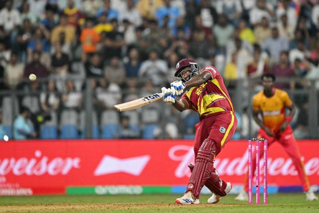 West Indies' Romario Shepherd plays a shot during the 2026 ICC Men's T20 Cricket World Cup Super Eights match between West Indies and Zimbabwe at the Wankhede Stadium in Mumbai on February 23, 2026. (Photo by Indranil MUKHERJEE / AFP)