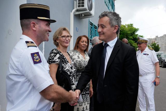 French Minister of Justice, Gerald Darmanin (R) greets the commanding officer of the RSMA Mayotte (French overseas military adapted service regiment) Benjamin Soubra, in front of the new open-environment educational unit, in Pamandzi, on the French Indian Ocean territory of Mayotte, on February 23, 2026.

Since Cyclone Chido struck Frances poorest department, the Minister of Justice is visiting Mayotte, where there are concerns over the prison system and the functioning of the court, on February 23, 2026. (Photo by Marine GACHET / AFP)