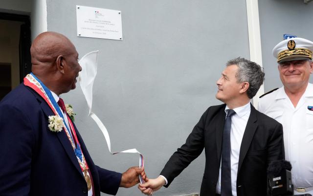 French Minister of Justice, Gerald Darmanin (2ndR), and Pamandzi Mayor, Madi Madi Souf (L), unveil a plaque as they inaugurate the new open-environment educational unit, in Pamandzi, on the French Indian Ocean territory of Mayotte, on February 23, 2026. (Photo by Marine GACHET / AFP)