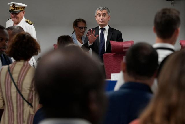 French Minister of Justice Gerald Darmanin (C) gestures before a meeting with judges and prosecutors at the Mamoudzou courthouse, in Mamoudzou, on the French Indian Ocean territory of Mayotte, on February 23, 2026. (Photo by Marine GACHET / AFP)
