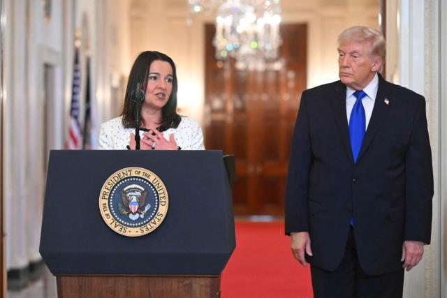 US President Donald Trump looks on as Allyson Phillips, the mother of Laken Riley, a 22-year-old nursing student who was murdered in 2024 by a Venezuelan man who entered the US illegally, speaks during the Angel Families Remembrance Ceremony in the East Room of the White House in Washington, DC, on February 23, 2026. Laken Riley, a 22-year-old University of Georgia nursing student who was murdered in 2024 by an undocumented immigrant. (Photo by SAUL LOEB / AFP)
