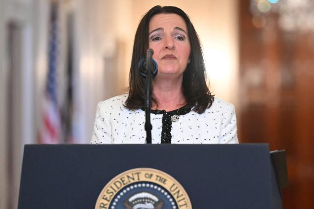 US President Donald Trump looks on as Allyson Phillips, the mother of Laken Riley, a 22-year-old nursing student who was murdered in 2024 by a Venezuelan man who entered the US illegally, speaks during the Angel Families Remembrance Ceremony in the East Room of the White House in Washington, DC, on February 23, 2026. Laken Riley, a 22-year-old University of Georgia nursing student who was murdered in 2024 by an undocumented immigrant. (Photo by SAUL LOEB / AFP)