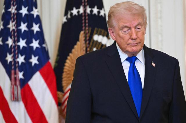US President Donald Trump looks on during the Angel Families Remembrance Ceremony in the East Room of the White House in Washington, DC, on February 23, 2026. (Photo by SAUL LOEB / AFP)