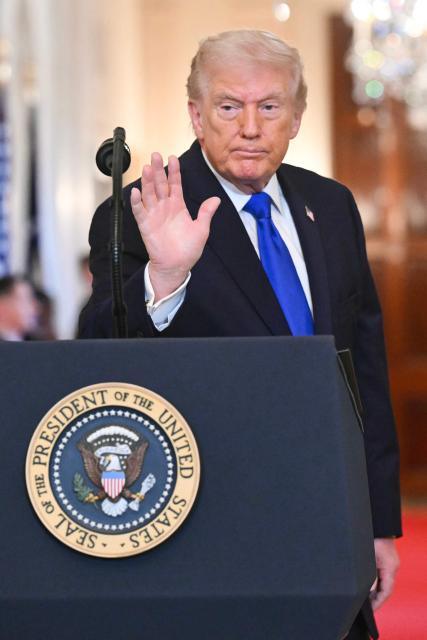 US President Donald Trump waves he departs an Angel Families Remembrance Ceremony in the East Room of the White House in Washington, DC, on February 23, 2026. (Photo by SAUL LOEB / AFP)