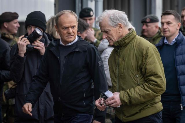 Poland's Prime Minister Donald Tusk (L) and Norway's Prime Minister Jonas Gahr Store are pictured during their meeting on February 23, 2026, in Camp Jomsborg - Norwegian Army training camp located in Lipa, south-eastern Poland, established to train Ukrainian soldiers. (Photo by Wojtek RADWANSKI / AFP)