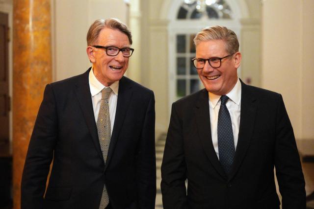 (FILES) British Prime Minister Keir Starmer (R) talks with Britain's Ambassador to the United States Peter Mandelson during a welcome reception at the ambassador's residence on February 26, 2025 in Washington, DC. Police on February 23, 2026 arrested former British ambassador to the United States Peter Mandelson in a misconduct in public office probe, amid allegations over his ties to disgraced US financier Jeffrey Epstein. "Officers have arrested a 72-year-old man on suspicion of misconduct in public office," the Metropolitan police said in a statement, following previous searches of Mandelson's home and as broadcast footage appeared to show Mandelson being driven away from his home. (Photo by Carl Court / POOL / AFP)