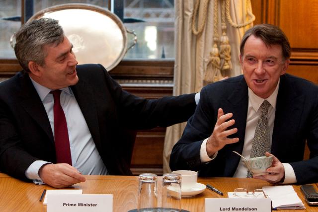 (FILES) British Prime Minister Gordon Brown (L) pats Business Secretary Peter Mandelson on the back as he hosts a breakfast and roundtable discussion for leading women in business at 10 Downing Street, in central London, on March 8, 2010. Police on February 23, 2026 arrested former British ambassador to the United States Peter Mandelson in a misconduct in public office probe, amid allegations over his ties to disgraced US financier Jeffrey Epstein. "Officers have arrested a 72-year-old man on suspicion of misconduct in public office," the Metropolitan police said in a statement, following previous searches of Mandelson's home and as broadcast footage appeared to show Mandelson being driven away from his home. (Photo by Carl COURT / POOL / AFP)