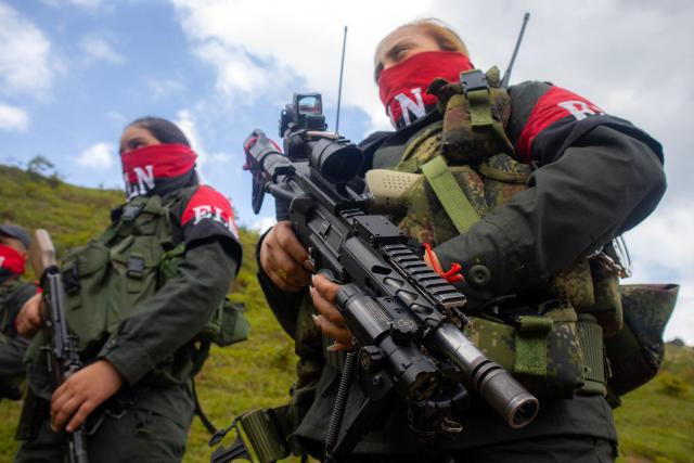 (FILES) National Liberation Army ELN rebels of the Manuel Vazquez Castano northeastern war front stand guard at Catatumbo region, Colombia on March 8, 2025. Colombia's largest guerrilla group on February 23, 2026 announced a unilateral ceasefire during upcoming elections, amid a surge in political violence including attacks, kidnappings and threats against candidates and leaders. (Photo by AFP)