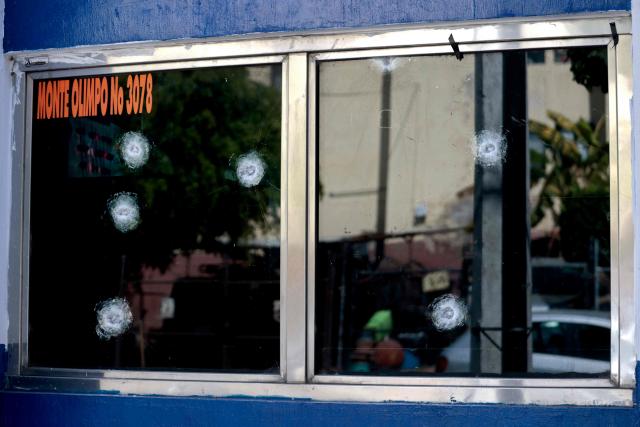 View of bullet inpacts on the window of a police station in Guadalajara, Jalisco, Mexico, on February 23, 2026, a day after clashes. Mexico has deployed 10,000 troops to quell clashes sparked by the killing of the country's most-wanted drug lord, Nemesio "El Mencho" Oseguera, leader of the Jalisco New Generation Cartel (CJNG), that have claimed dozens of lives, officials said on February 23. News of his death triggered spasms of violence, with cartel members blocking roads in 20 states and torching vehicles and businesses. (Photo by Ulises RUIZ / AFP)