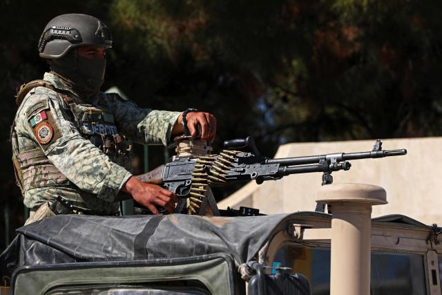 A soldier from the Mexican Army guards the facilities of the Military Garrison in Ciudad Juarez, Chihuahua state, Mexico, on February 23, 2026. Mexico has deployed 10,000 troops to quell clashes sparked by the killing of the country's most wanted drug lord, which have left dozens dead, officials said on February 23. Nemesio "El Mencho" Oseguera, leader of the Jalisco New Generation Cartel (CJNG), was wounded on February 22 in a shootout with soldiers in the town of Tapalpa in Jalisco state and died while being flown to Mexico City, the army said. (Photo by Herika Martinez / AFP)