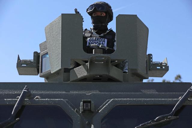 A soldier from the Mexican Army guards the facilities of the Military Garrison in Ciudad Juarez, Chihuahua state, Mexico, on February 23, 2026. Mexico has deployed 10,000 troops to quell clashes sparked by the killing of the country's most wanted drug lord, which have left dozens dead, officials said on February 23. Nemesio "El Mencho" Oseguera, leader of the Jalisco New Generation Cartel (CJNG), was wounded on February 22 in a shootout with soldiers in the town of Tapalpa in Jalisco state and died while being flown to Mexico City, the army said. (Photo by Herika Martinez / AFP)
