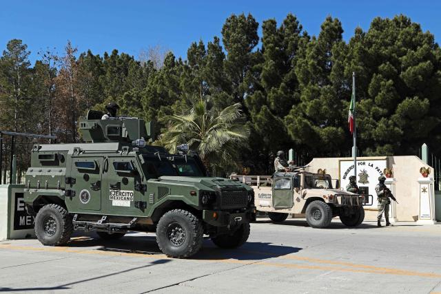 Soldiers from the Mexican Army guard the facilities of the Military Garrison in Ciudad Juarez, Chihuahua state, Mexico, on February 23, 2026. Mexico has deployed 10,000 troops to quell clashes sparked by the killing of the country's most wanted drug lord, which have left dozens dead, officials said on February 23. Nemesio "El Mencho" Oseguera, leader of the Jalisco New Generation Cartel (CJNG), was wounded on February 22 in a shootout with soldiers in the town of Tapalpa in Jalisco state and died while being flown to Mexico City, the army said. (Photo by Herika Martinez / AFP)