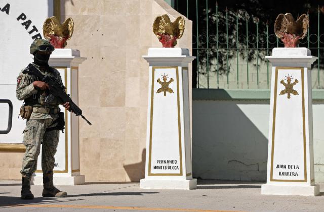 A soldier from the Mexican Army guards the facilities of the Military Garrison in Ciudad Juarez, Chihuahua state, Mexico, on February 23, 2026. Mexico has deployed 10,000 troops to quell clashes sparked by the killing of the country's most wanted drug lord, which have left dozens dead, officials said on February 23. Nemesio "El Mencho" Oseguera, leader of the Jalisco New Generation Cartel (CJNG), was wounded on February 22 in a shootout with soldiers in the town of Tapalpa in Jalisco state and died while being flown to Mexico City, the army said. (Photo by Herika Martinez / AFP)
