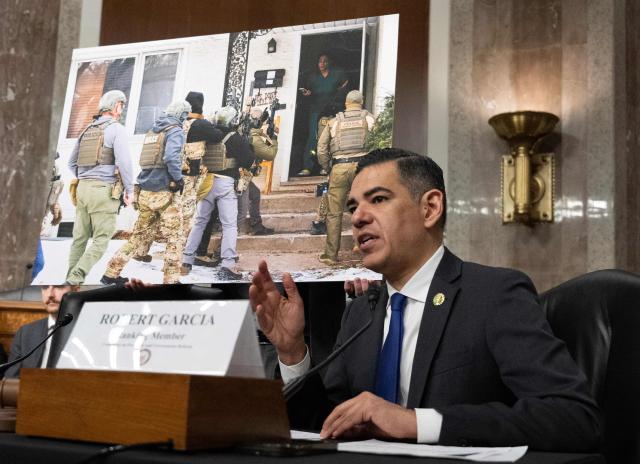 US House Oversight and Government Reform Committee ranking member Representative Robert Garcia, Democrat of California, speaks in front of a picture of Teyana Gibson Brown, a resident of Minneapolis, Minnesota, confronting federal agents as they raid her home during a forum on Immigration and Customs Enforcement (ICE) at the Dirksen Senate Office Building at the US Capitol on February 23, 2026 in Washington, DC. (Photo by ANDREW CABALLERO-REYNOLDS / AFP)
