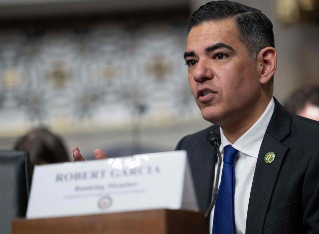 US House Oversight and Government Reform Committee ranking member Representative Robert Garcia, Democrat of California, speaks in front of a picture of Teyana Gibson Brown, a resident of Minneapolis, Minnesota, confronting federal agents as they raid her home during a forum on Immigration and Customs Enforcement (ICE) at the Dirksen Senate Office Building at the US Capitol on February 23, 2026 in Washington, DC. (Photo by ANDREW CABALLERO-REYNOLDS / AFP)