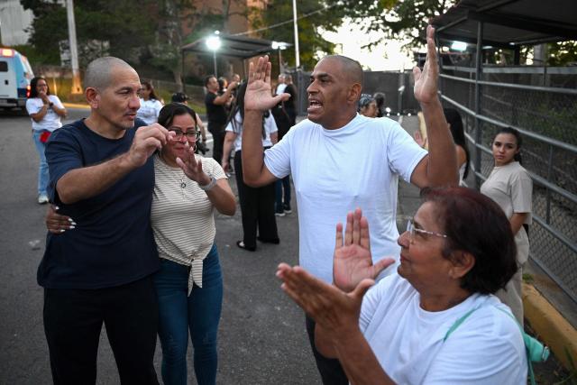 Venezuelan prisoners and relatives shout "Freedom" after their release from El Rodeo I prison in Guatire, Miranda state, Venezuela on February 23, 2026. At least 30 political prisoners were released from a prison on the outskirts of Caracas on the afternoon of February 23, 2026, under a historic amnesty law enacted in Venezuela under pressure from Washington, AFP journalists reported. (Photo by Federico PARRA / AFP)