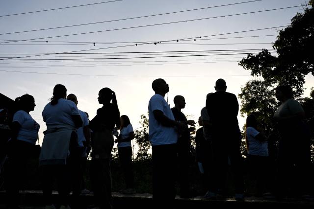 Venezuelan prisoners gather with relatives after their release from El Rodeo I prison in Guatire, Miranda state, Venezuela on February 23, 2026. At least 30 political prisoners were released from a prison on the outskirts of Caracas on the afternoon of February 23, 2026, under a historic amnesty law enacted in Venezuela under pressure from Washington, AFP journalists reported. (Photo by Federico PARRA / AFP)