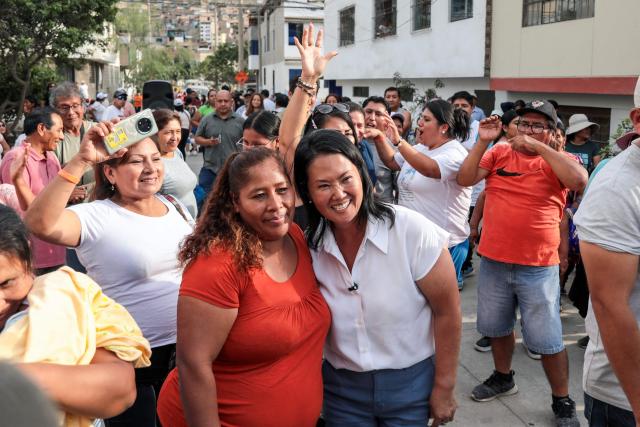 Peruvian presidential candidate of the People's Force party, Keiko Fujimori (R), poses for a photo with a supporter during a campaign event at Valle Alto health centre in Lima on February 23, 2026. Peru will hold a presidential election on April 12, 2026. (Photo by Connie FRANCE / AFP)