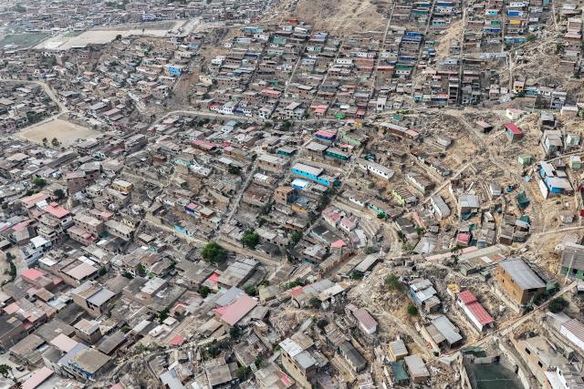 This aerial view shows the Valle Alto human settlement of the Villa Maria del Triunfo district in Lima on February 23, 2026. Peru will hold a presidential election on April 12, 2026. (Photo by Connie FRANCE / AFP)