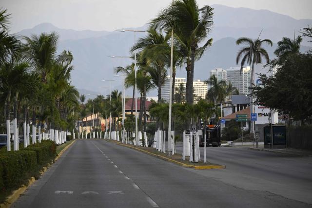 General view of an empty street in Puerto Vallarta, Jalisco state, Mexico, on February 23, 2026. Mexico has deployed 10,000 troops to quell clashes sparked by the killing of the country's most wanted drug lord, which have left dozens dead, officials said on February 23. Nemesio "El Mencho" Oseguera, leader of the Jalisco New Generation Cartel (CJNG), was wounded on February 22 in a shootout with soldiers in the town of Tapalpa in Jalisco state and died while being flown to Mexico City, the army said. (Photo by Alfredo ESTRELLA / AFP)