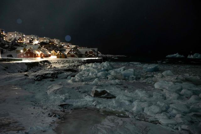 Icebergs accumulate on the beach while snow accumulates in a neighborhood in Nuuk, Greenland, on February 23, 2026. (Photo by Florent VERGNES / AFP)
