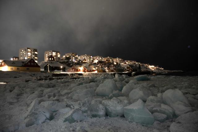 Icebergs accumulate on the beach while snow accumulates in a neighborhood in Nuuk, Greenland, on February 23, 2026. (Photo by Florent VERGNES / AFP)